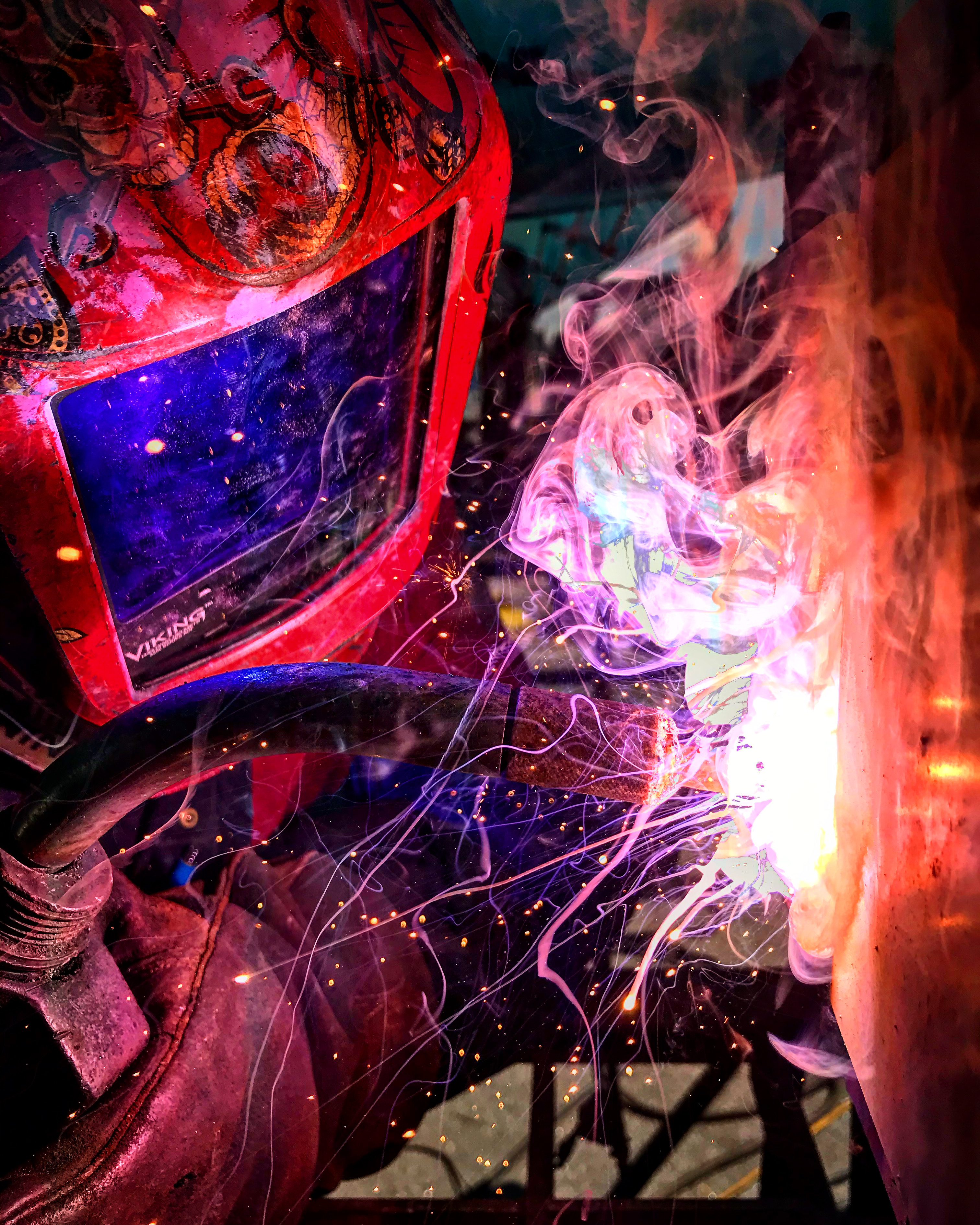 person welding with mask on